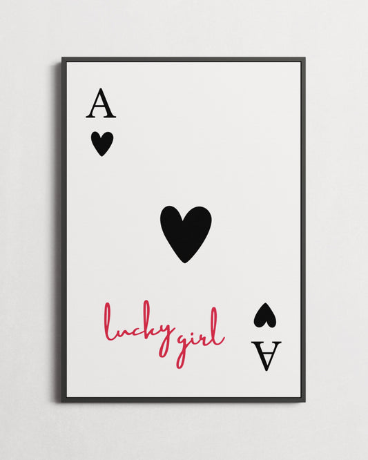 Framed artwork with playing card design and 'lucky girl' text on a light gray background