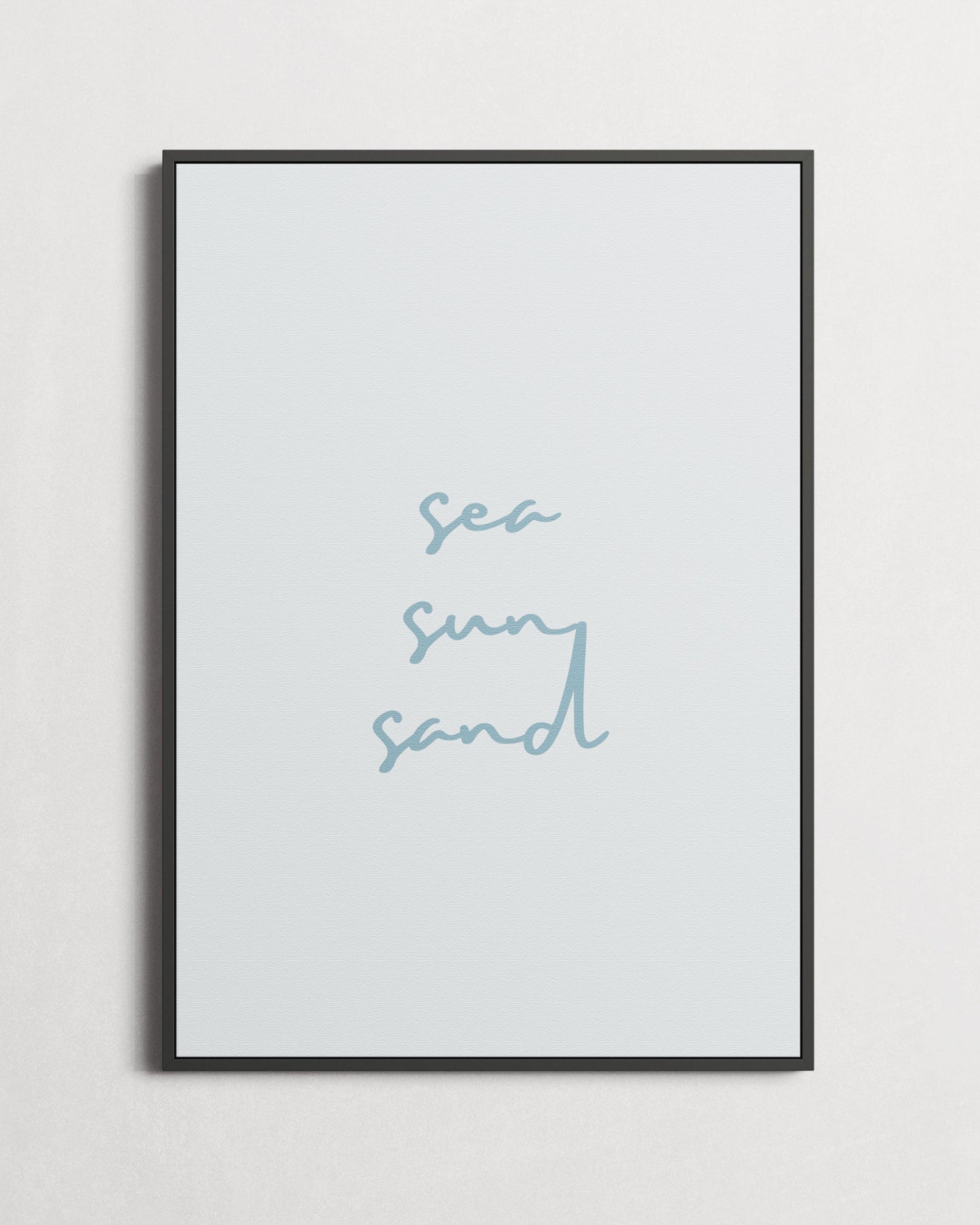 Framed artwork with 'sea sun sand' text on a light gray background