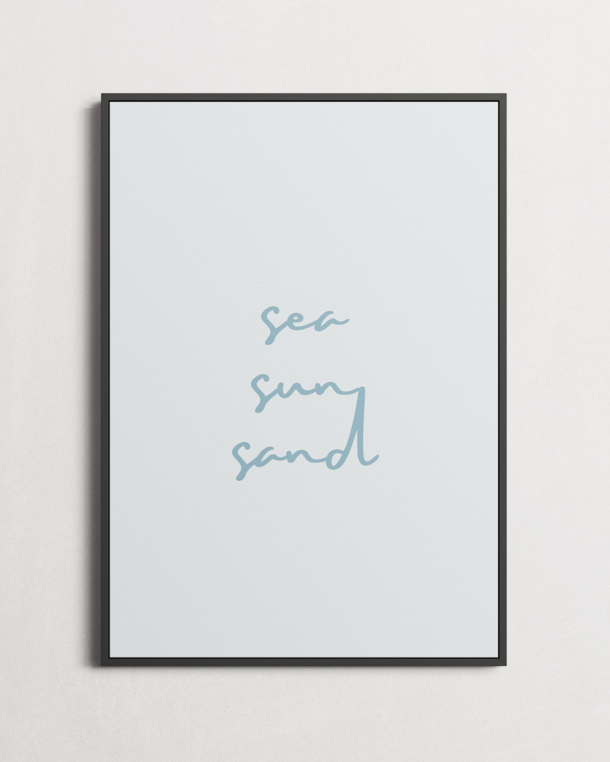 Framed artwork with 'sea sun sand' text on a light gray background